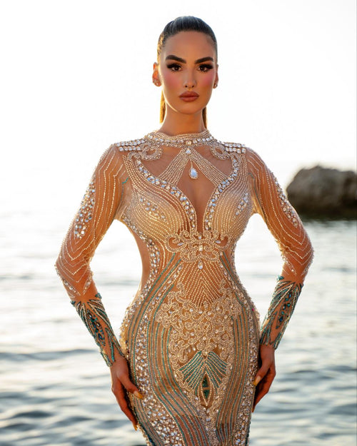 Woman wearing a intricately designed dress with a blurred natural background